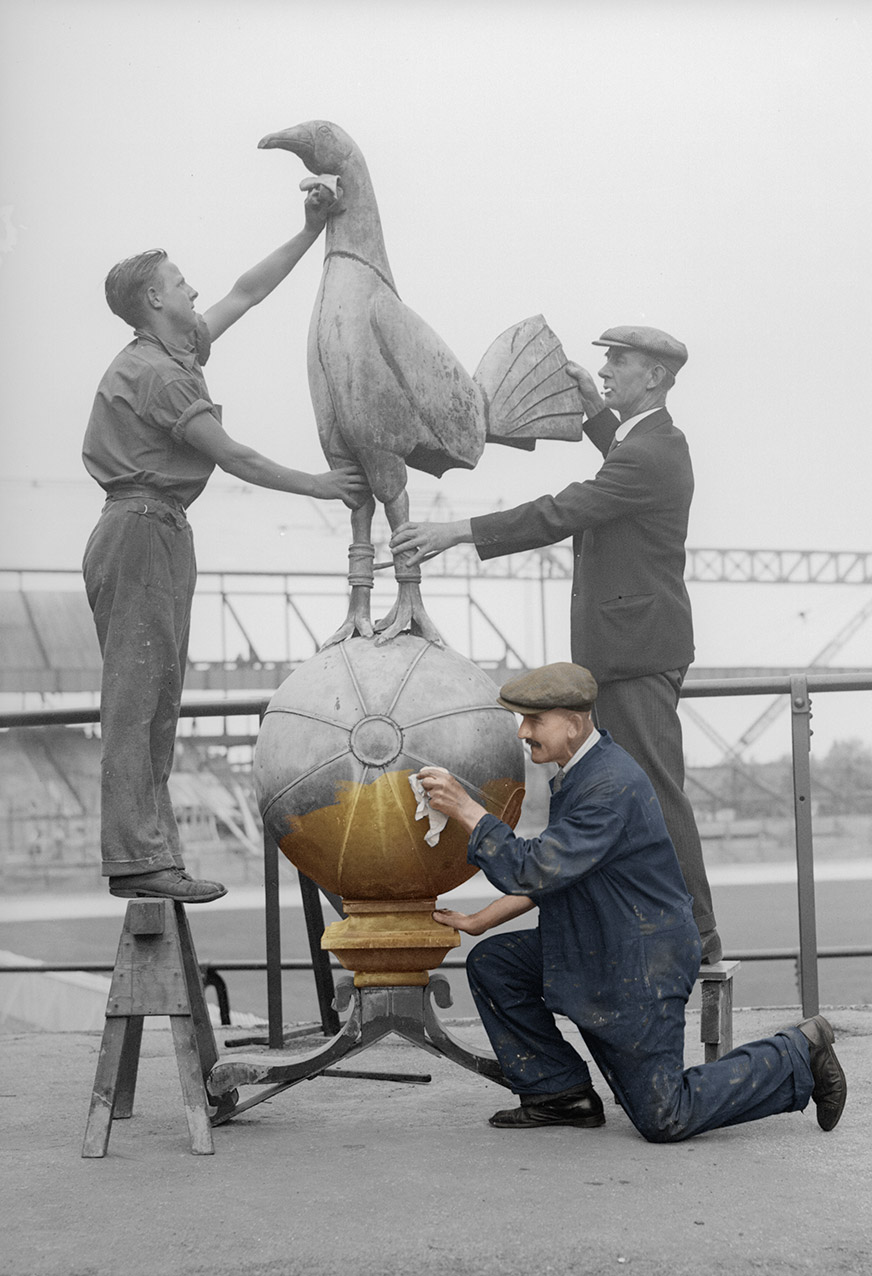 Gentleman cleaning the Tottenham Cockerel, revealing colour