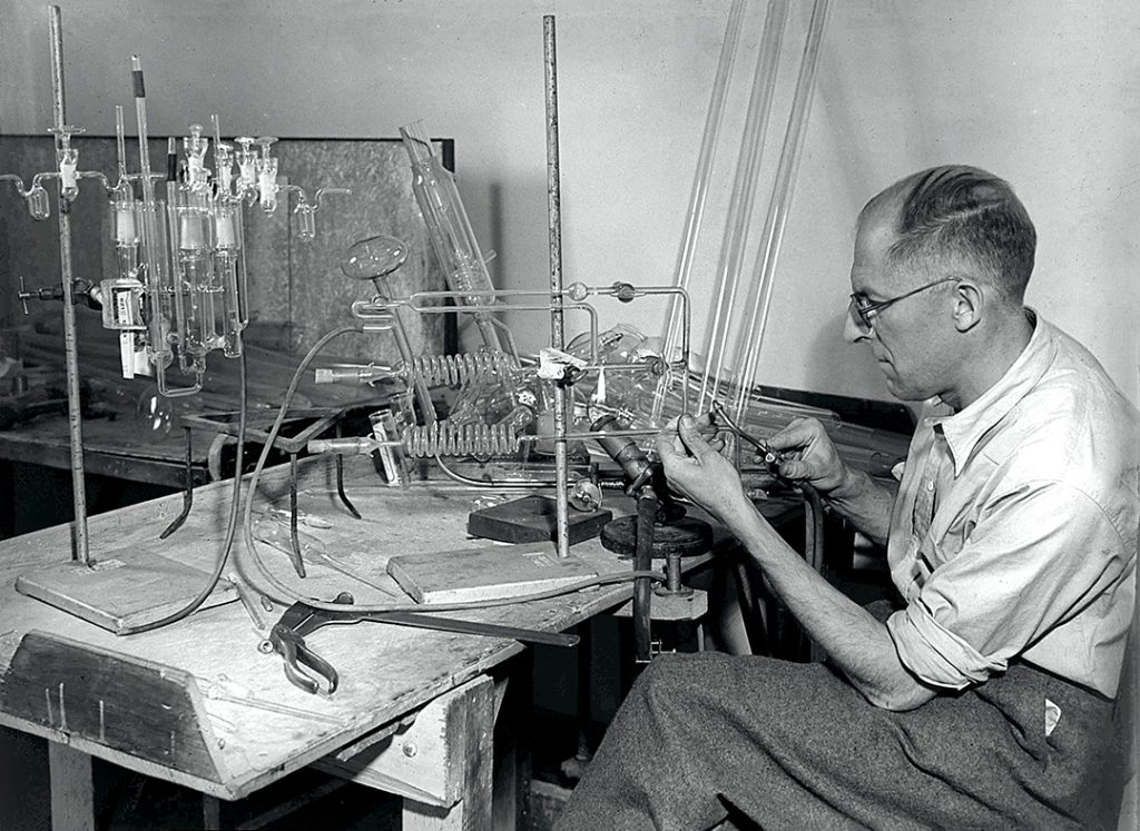 Thomas William Wingent at his work bench, constructing a large glass apparatus