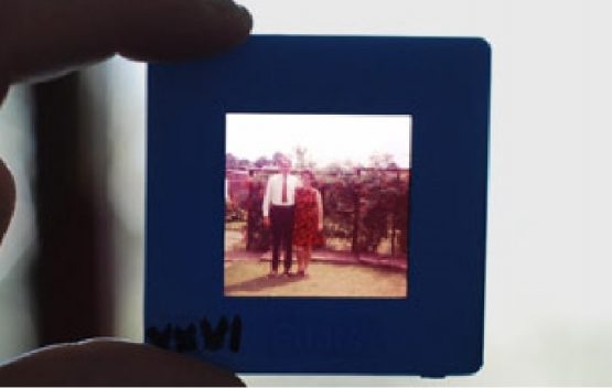 holding a 35mm slide to scan