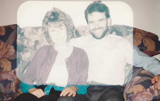 Sun damaged photo of couple sitting on sofa