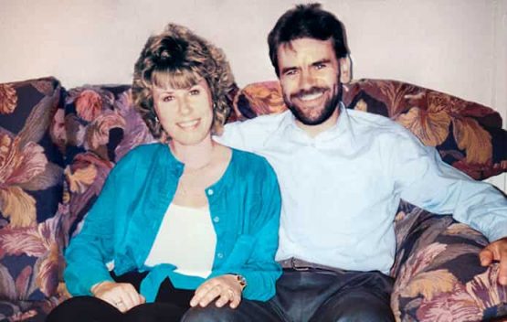 Repaired sun damaged photo of couple sitting on sofa