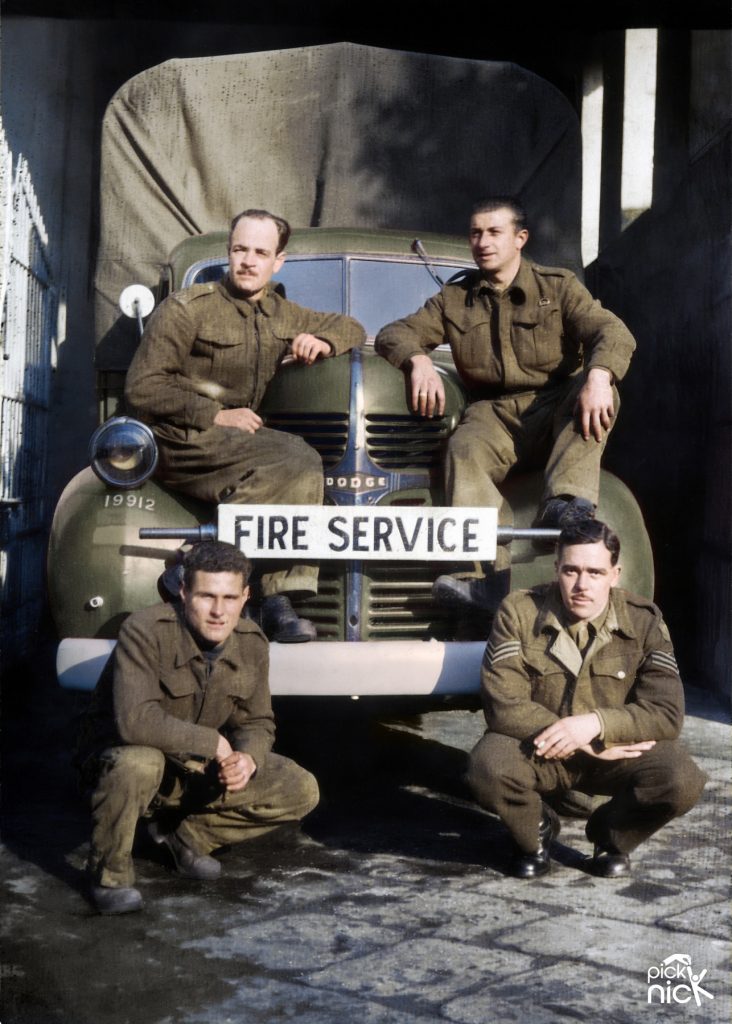 Colourised Photo of Leslie with his 151 Firefighting Company Squadron, infront of a Dodge WF-32 Fire Truck